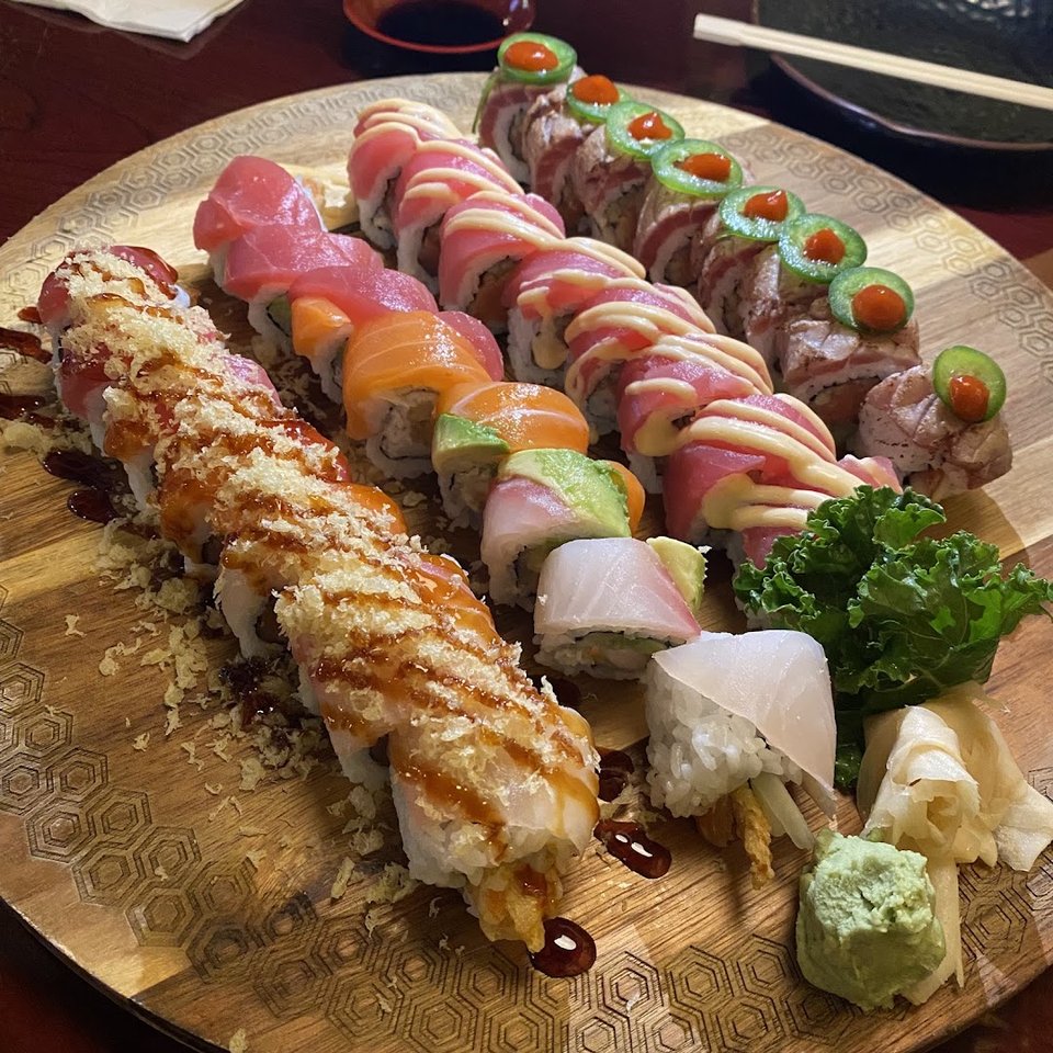 Small plates served beside chopsticks and soy sauce.
