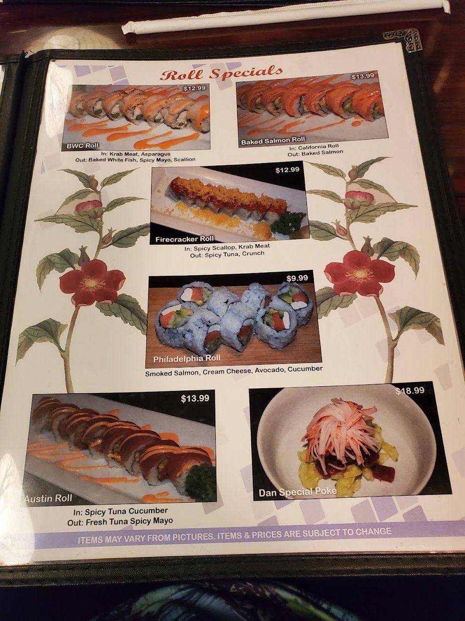 Japanese menu beside a plate of sushi.